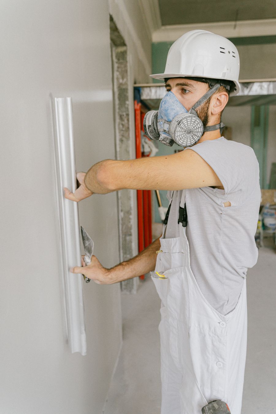 Worker smoothing a wall during renovation