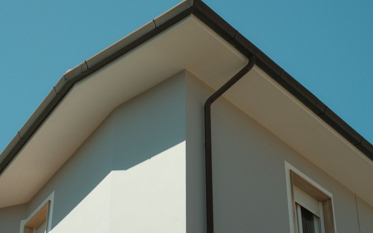 Gutters and downspouts running down the side of a building